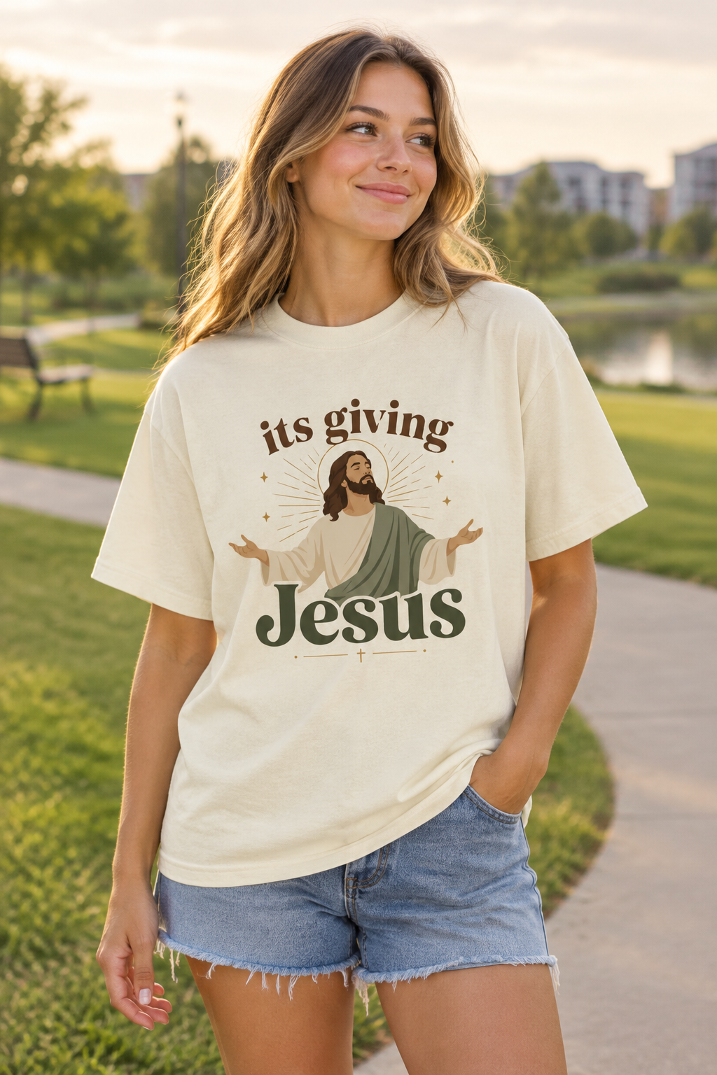 Young adult wearing the “its giving Jesus” tee in a softly lit park
